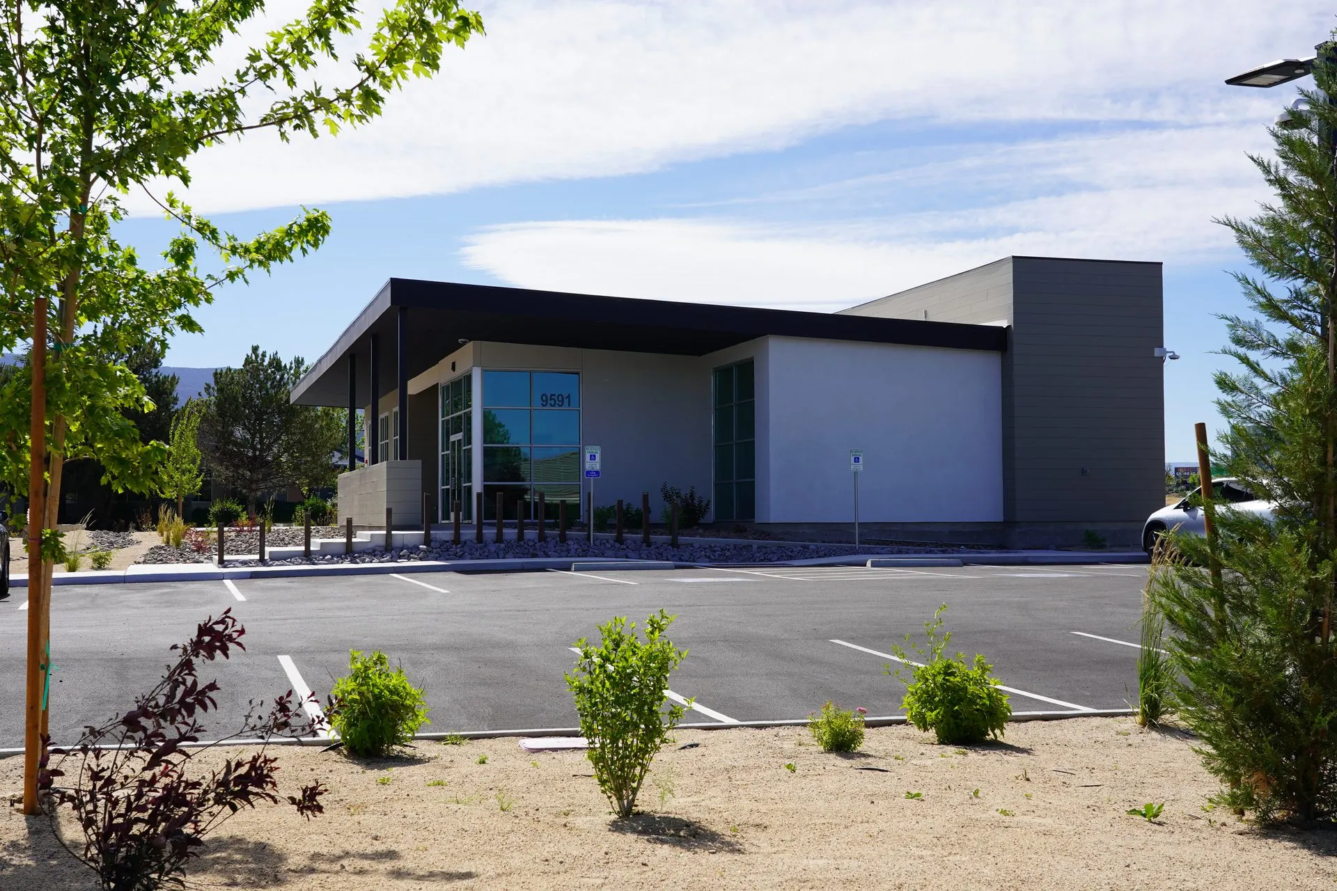 Modern commercial office building exterior with completed site work