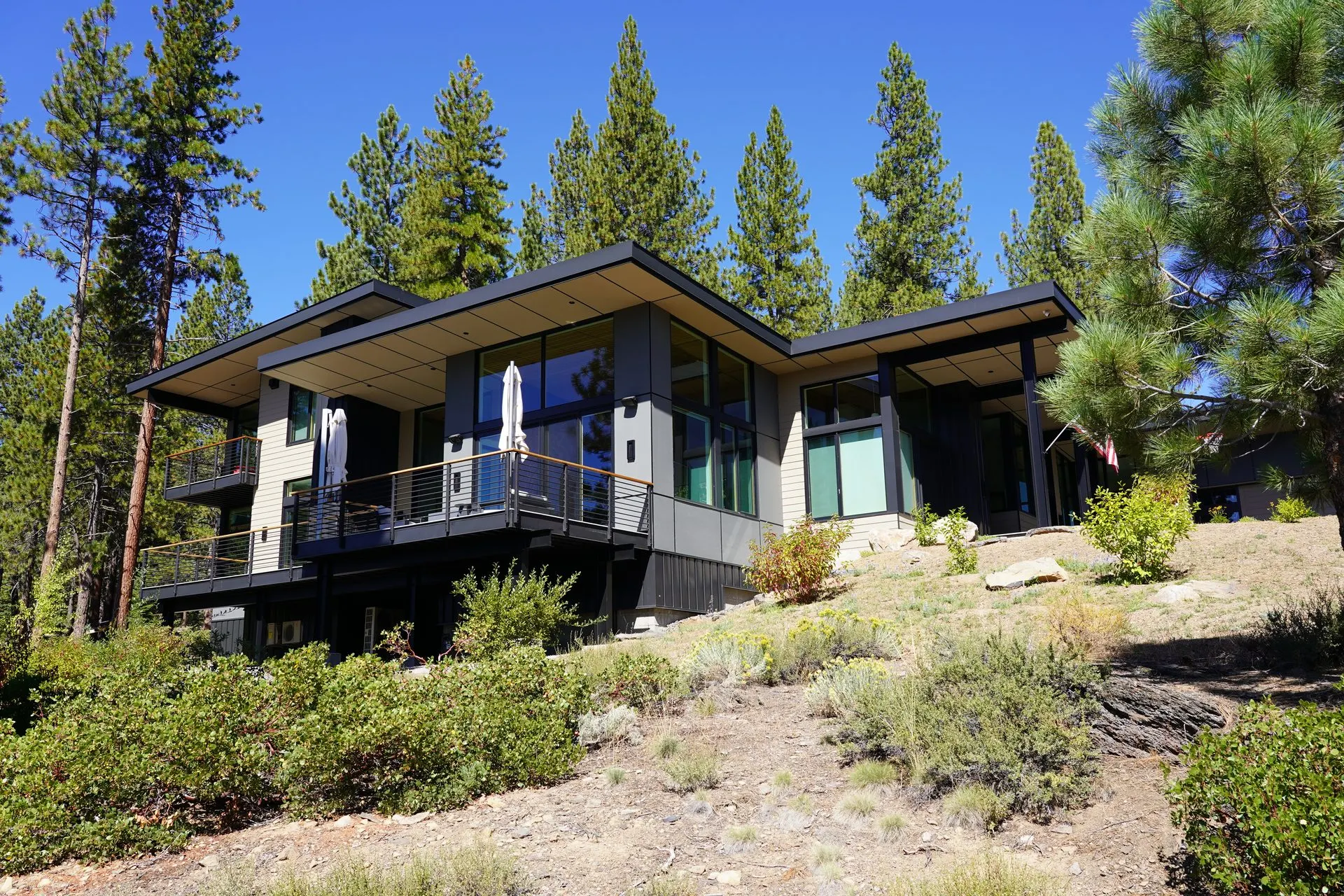 Contemporary custom home in forested setting with graded driveway access