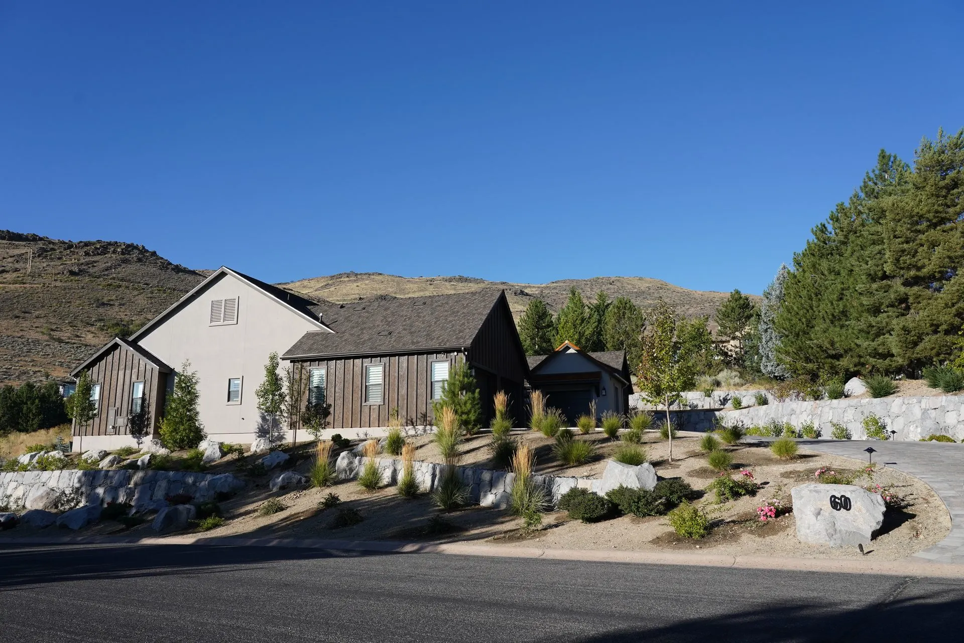 Custom desert home exterior with graded pad and driveway