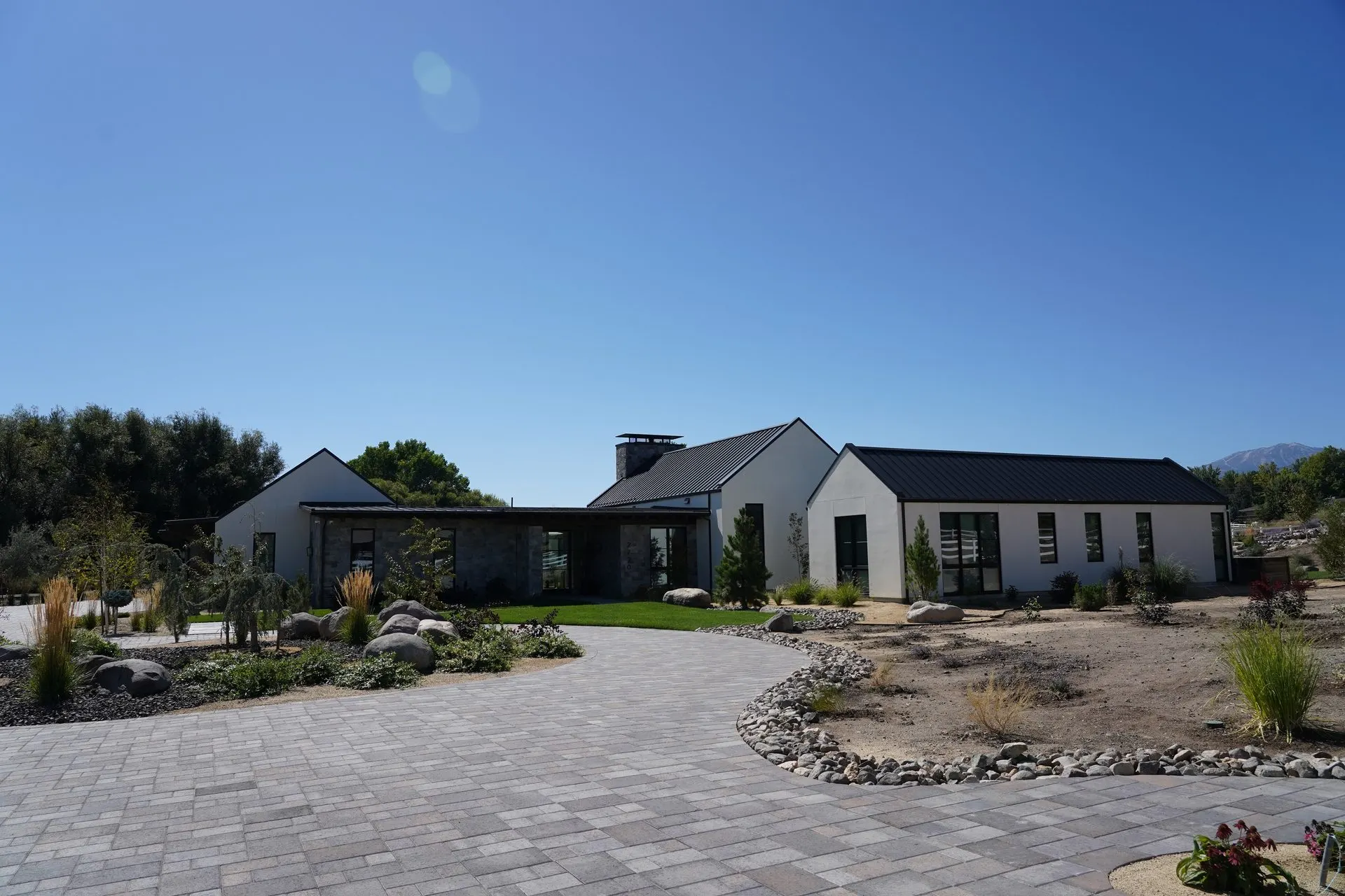 Modern ranch-style custom home exterior with graded site