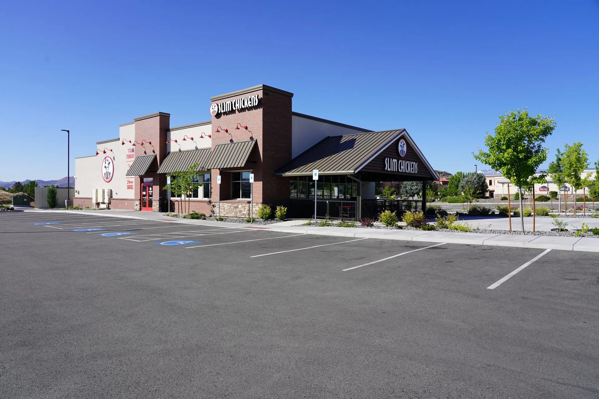 Slim Chickens restaurant with completed parking lot, ADA stalls, and accessible route